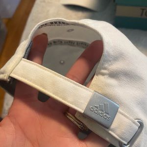 Adidas white hat has some marks but still hs life to it